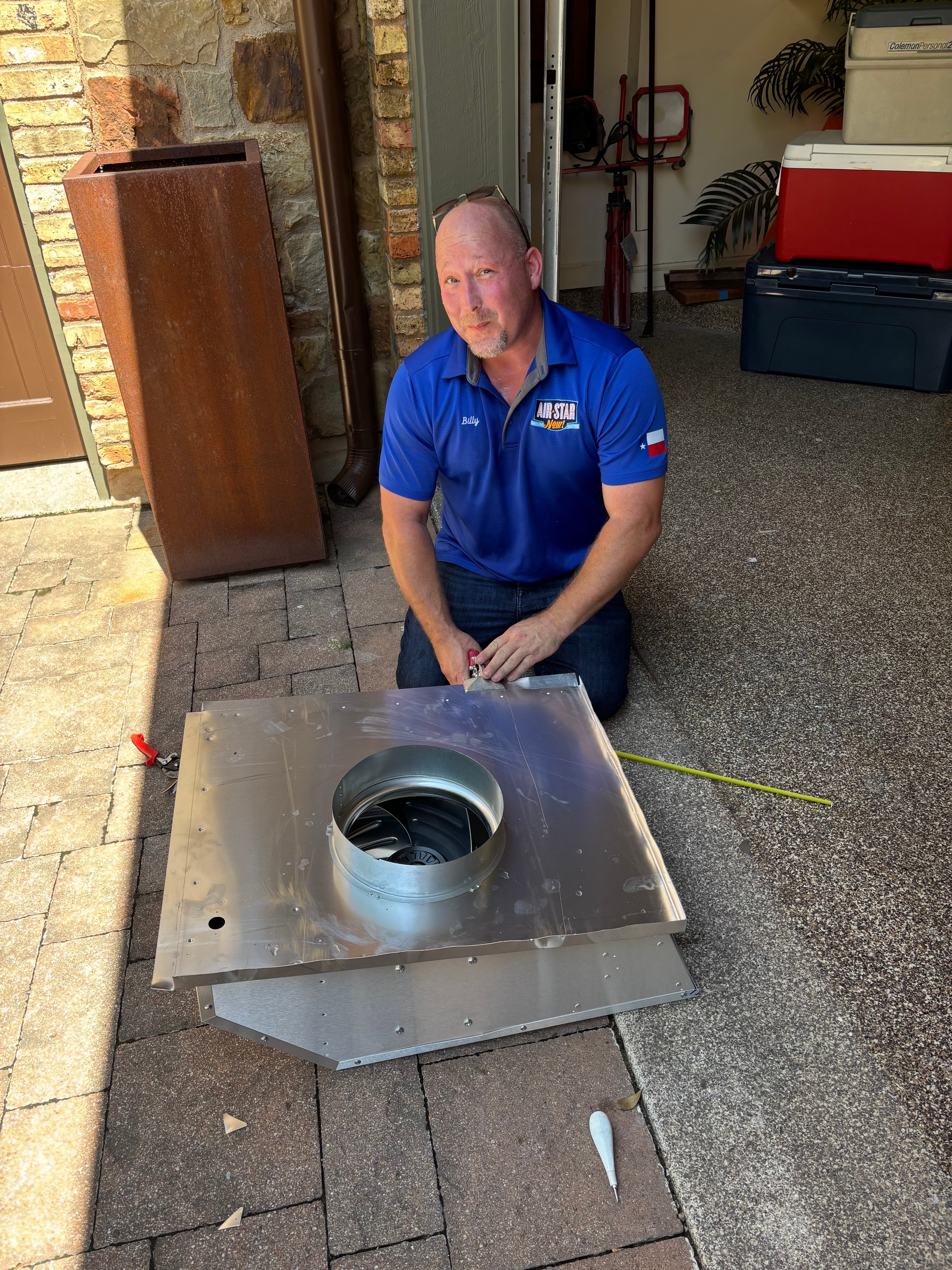 An Air Star Now technician assembling a blower unit on-site