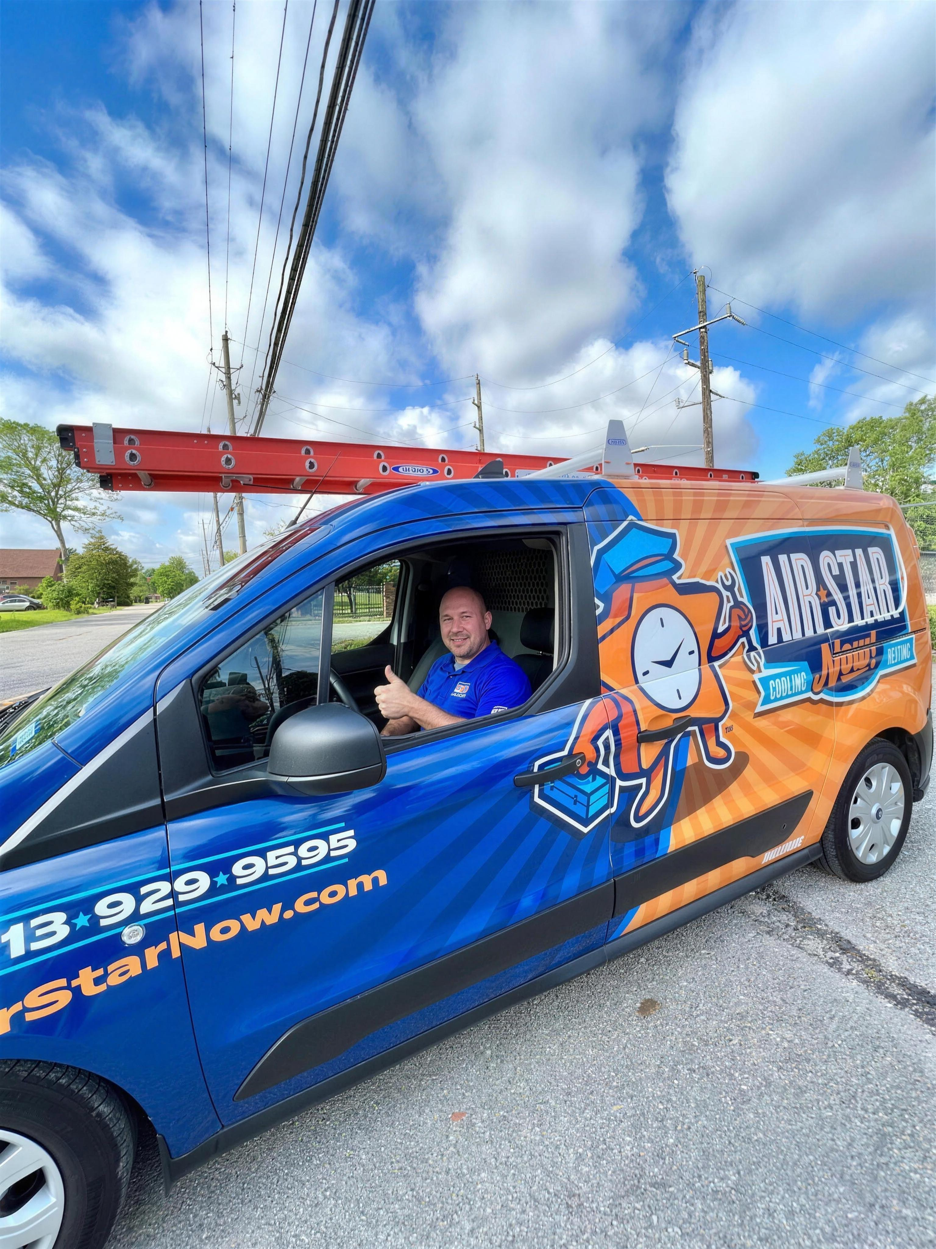 An Air Star Now technician giving a thumbs up from a fully loaded branded van